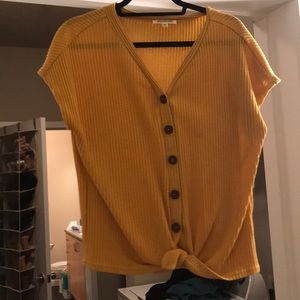 An orange button down shirt with tie